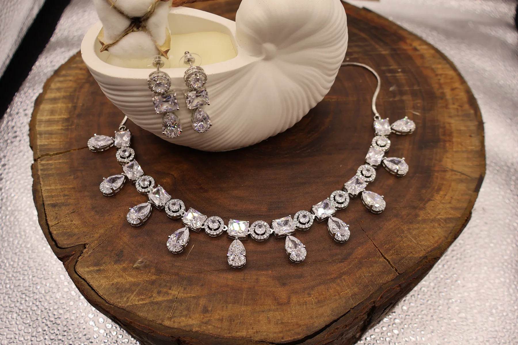 Close view of clear crystal geometric drop necklace and earrings